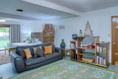 a living room with a couch and a bed at Casa Mariposa in Esterillos