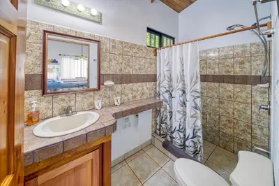a bathroom with a sink and a shower at Casa Mariposa in Esterillos