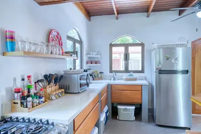 a kitchen with a stainless steel refrigerator and a stove at Casa Mariposa in Esterillos