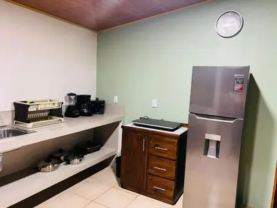 a kitchen with a stainless steel refrigerator and a sink at Arenal Harmony-Acogedor Apartamento-La Fortuna in Fortuna