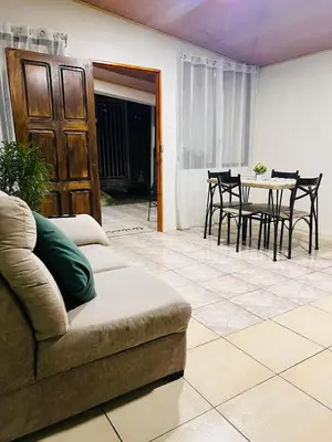a living room with a couch and a table at Arenal Harmony-Acogedor Apartamento-La Fortuna in Fortuna