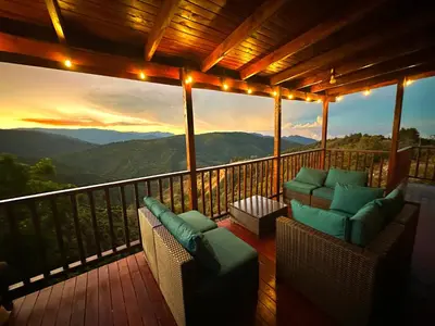 a balcony with chairs and a view of the mountains at Cabaña Nora in Cedral