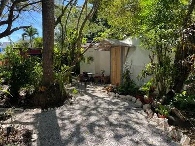 a garden path leading to a house with a table at La Selva in Hojancha