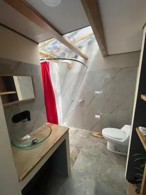 a bathroom with a shower and a toilet at La Selva in Hojancha