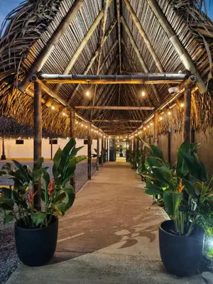a covered walkway with potted plants in a building at Bahia Selvatica Lodge in Uvita