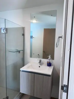 a bathroom with a sink and a glass shower at 16th Floor Oceanview Bliss in Jacó