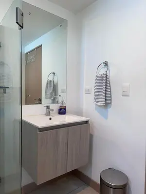 a bathroom with a sink and a mirror at 16th Floor Oceanview Bliss in Jacó