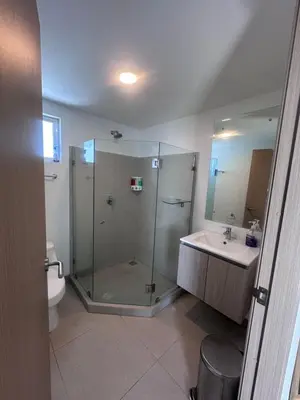 a bathroom with a shower and a sink and a toilet at 16th Floor Oceanview Bliss in Jacó