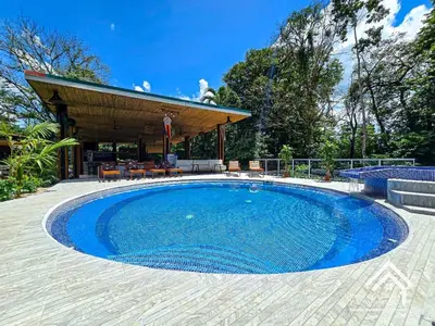 a large swimming pool in a patio with a pavilion at La Granja Boutique Nature Luxury and Relaxation in Guayabal