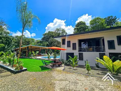 a backyard of a house with a table and umbrella at La Granja Boutique Nature Luxury and Relaxation in Guayabal