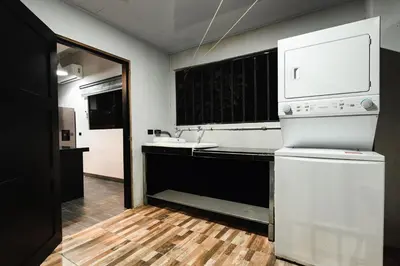 a kitchen with a sink and a white appliance at La Granja Boutique Nature Luxury and Relaxation in Guayabal