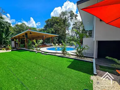 a backyard with a lawn and a swimming pool at La Granja Boutique Nature Luxury and Relaxation in Guayabal