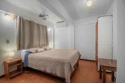 a bedroom with a bed and a table at Hotel el Tajalin in Montezuma