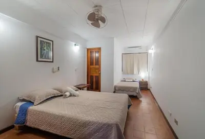 a bedroom with a bed with a stuffed animal on it at Hotel el Tajalin in Montezuma
