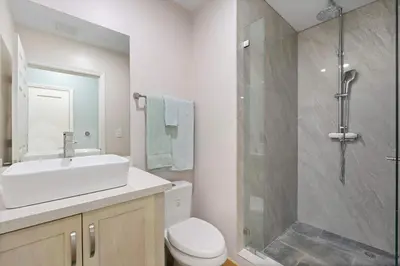 a bathroom with a toilet and a sink and a shower at Condo with Pool Tennis Pickleball in Ocotal