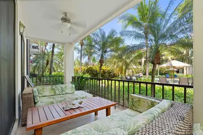 a porch with a couch and a table on a balcony at Condo with Pool Tennis Pickleball in Ocotal