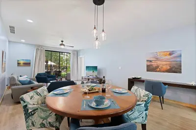 a living room with a table and chairs at Condo with Pool Tennis Pickleball in Ocotal