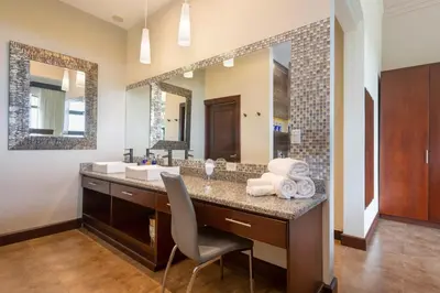 a bathroom with a sink and a large mirror at Villa Buena Onda All Inclusive in Coco