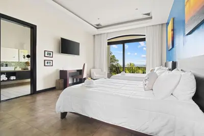 a bedroom with a large white bed and a balcony at Villa Buena Onda All Inclusive in Coco