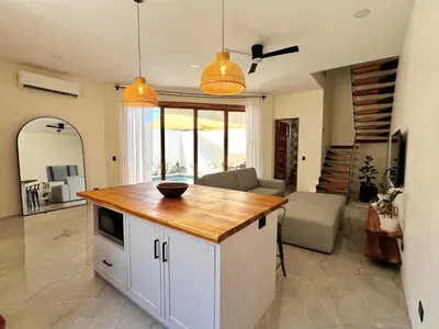 a kitchen with a island in a living room at Casa María - Playa hermosa Cóbano in Playa hermosa