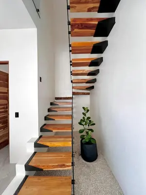 a staircase in a house with wooden floors and a plant at Casa María - Playa hermosa Cóbano in Playa hermosa