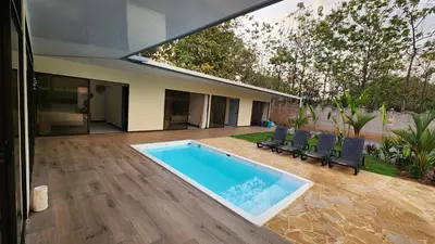 a swimming pool in the backyard of a house at Casa Mar Azul in Quepos