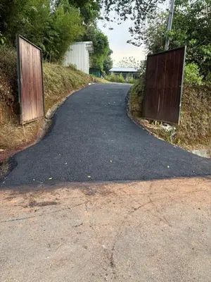 an empty road with two gates in the middle at El Cedro Lodge in Alajuela City