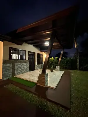 a rendering of a patio in a house at night at Trébol House in Cuatro Esquinas