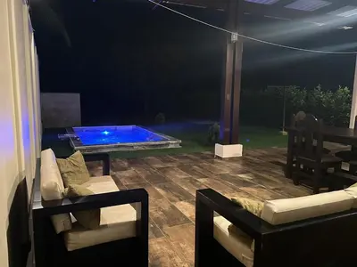 a patio with a swimming pool at night at Trébol House in Cuatro Esquinas