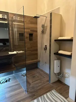 a bathroom with a shower with a glass door at Trébol House in Cuatro Esquinas