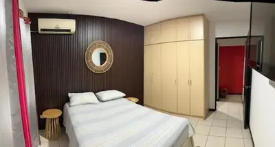 a bedroom with a large bed and a mirror at Verde y Mar in Herradura