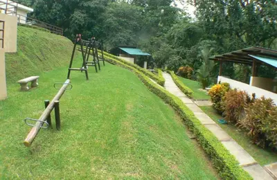 a park with a swing set in the grass at Verde y Mar in Herradura