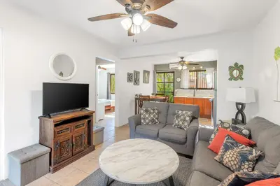a living room with a couch and a tv at Aqua Vista Ground Condo in Coco