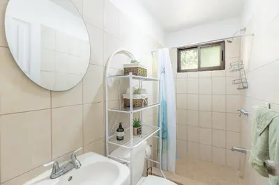 a bathroom with a sink and a mirror at Aqua Vista Ground Condo in Coco