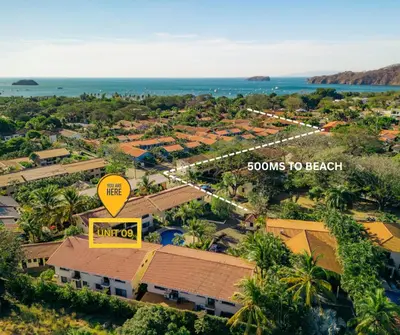 an overhead view of a resort with a sign that reads slows to beach at Aqua Vista Ground Condo in Coco