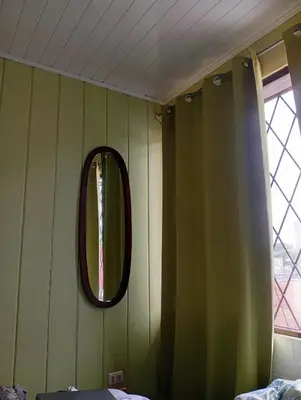 a room with a mirror on the wall at Manuel Antonio rooms in Quepos