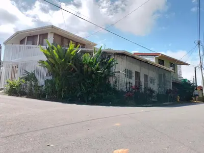 a house on the side of a street at Manuel Antonio rooms in Quepos