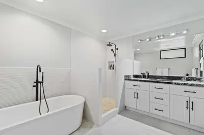 a white bathroom with a tub and a sink at Villa Isla Azul in Ocotal