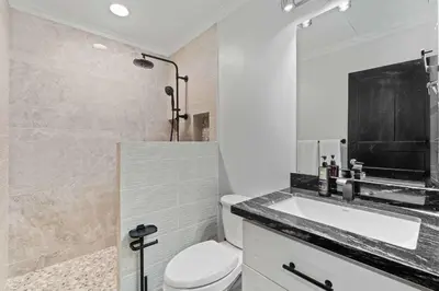 a bathroom with a white toilet and a sink at Villa Isla Azul in Ocotal