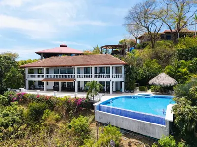 an aerial view of a house with a swimming pool at Villa Isla Azul in Ocotal
