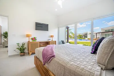 a bedroom with a large bed and a large window at The Enclave D9 in Playa Avellana