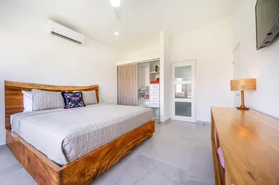 a bedroom with a bed and a table in it at The Enclave D9 in Playa Avellana