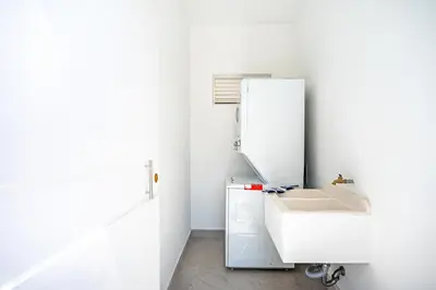 a white bathroom with a sink and a mirror at The Enclave D9 in Playa Avellana