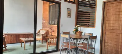a dining room with a table and chairs on a balcony at Peace at the Beach in Sámara