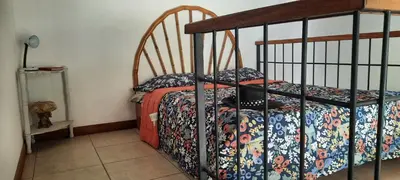 a bedroom with a bed with a blanket on it at Peace at the Beach in Sámara