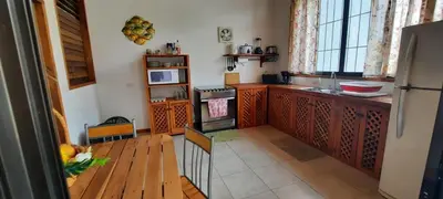 a kitchen with wooden cabinets and a stove top oven at Peace at the Beach in Sámara