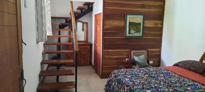 a bedroom with a bed and a spiral staircase at Peace at the Beach in Sámara