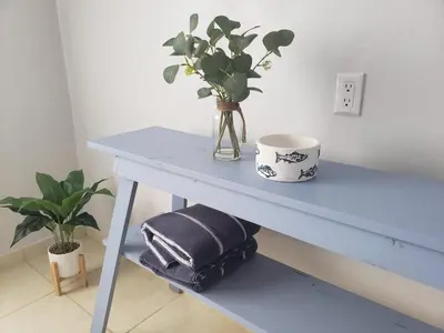a blue table with a vase with a plant on it at Aqua Heaven in Jabillos