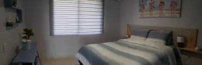 a bedroom with a bed and a window at Aqua Heaven in Jabillos