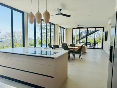 a kitchen and dining room with a table and chairs at Coco Rica Luxury Oceanview Villa Pool Concierge 4 Bedroom 6BED 5BA Playa Carrillo in Carrillo